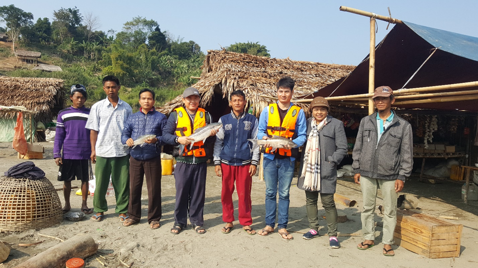 FISHBIO staff holding fish near the Chindwin River in Myanamr