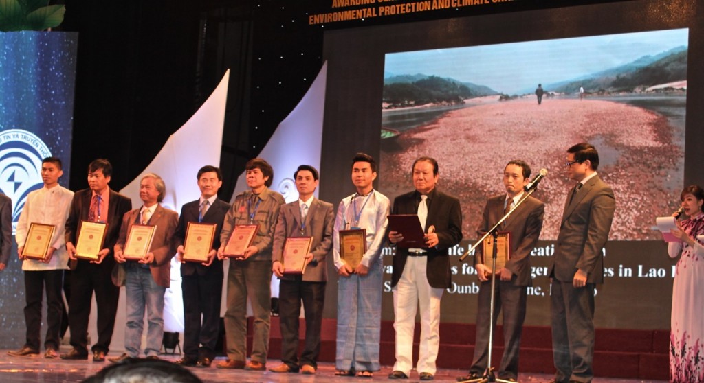 Sinsamout (fourth from left) with his prize-winning photo displayed